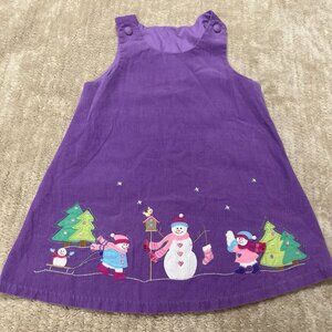 Purple corduroy jumper with a winter-themed appliqué featuring snowmen and pine